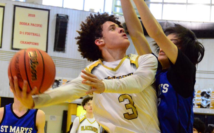 Humphreys' Brandon Howell tries to shoot against St. Mary's Towa Moyoshi. The Titans won 80-56.