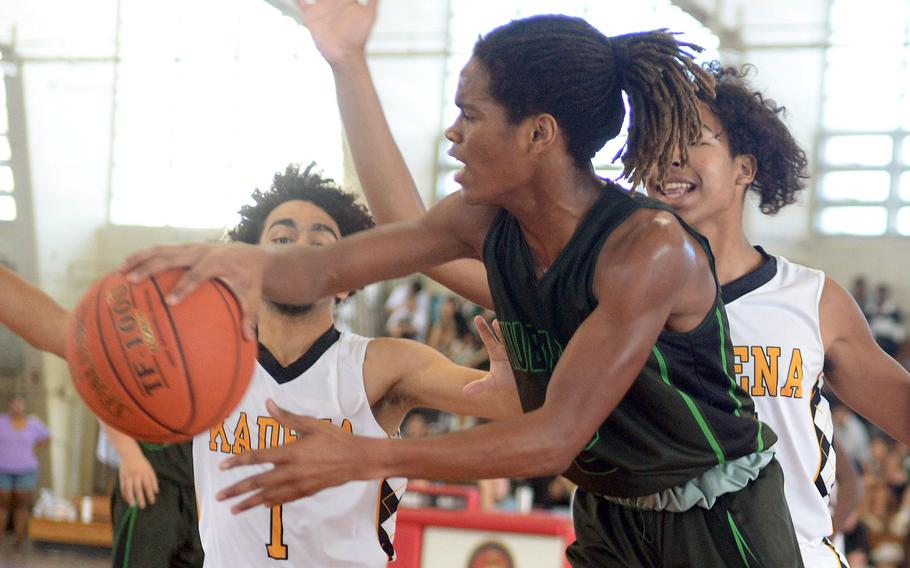 Kubasaki's Carlos Cadet passes around Kadena's Aslan Martinez and Cory Tripp during Sunday's semifinal, which the Panthers won 56-35.