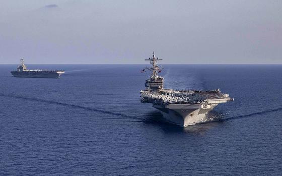 The aircraft carrier USS Harry S. Truman, right, sails with USS George H.W. Bush, in the Ionian Sea, Aug. 27, 2022. The Truman has since passed through the Strait of Gibraltar, into the Atlantic Ocean.