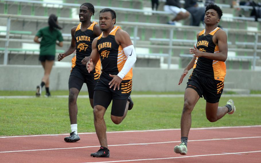 Senior D'Kylan Woods, middle, and teammates Carmelo Ward (junior) and Cedrick Dorelein (senior) help fill a deep lineup of sprinters for Kadena.