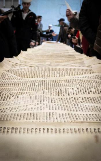 The Torah on the USS Harry S. Truman was unrolled to its full length in the aircraft carrier's hangar bay following a  dedication and reinstallation ceremony for it on the ship at Naval Station Norfolk, Va., March 2, 2024. Truman and USS Dwight D. Eisenhower both have Holocaust-surviving Torahs.  