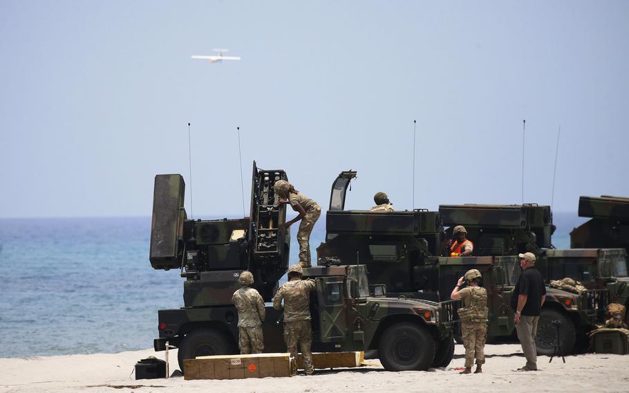 U.S. soldiers prepare to shoot down an MQM-170 Outlaw unmanned aerial vehicle with a .50 caliber machine gun and Stinger missiles during a Balikatan drill at Naval Station Leovigildo Gantioqui in San Antonio, Philippines, Tuesday, April 25, 2023.