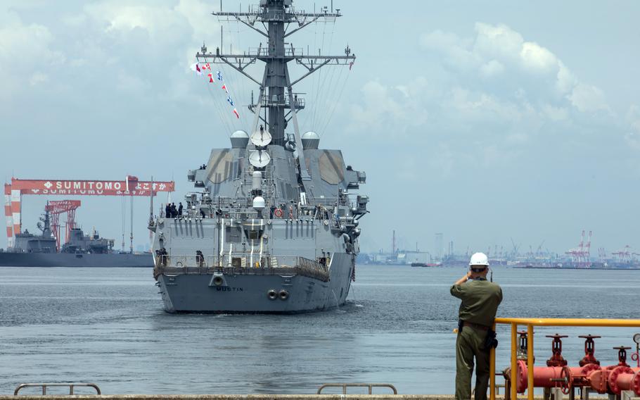 The guided-missile destroyer USS Mustin steams away from Yokosuka Naval Base, Japan, June 22, 2021.