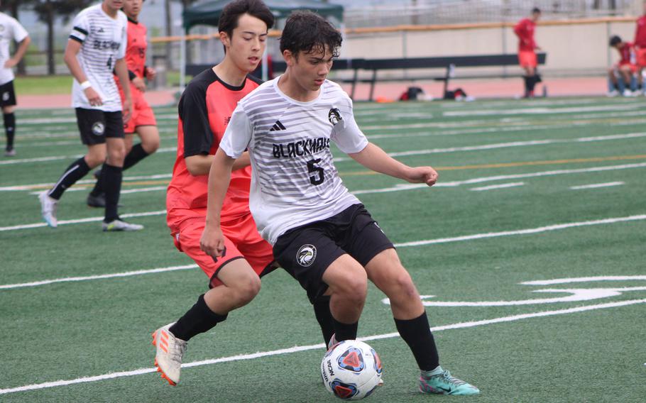 Humphreys’ Kylan Murray looks to move upfield against Nile C. Kinnick’s Luis Galloway during Monday’s boys Division I soccer match. The Red Devils won 3-1.