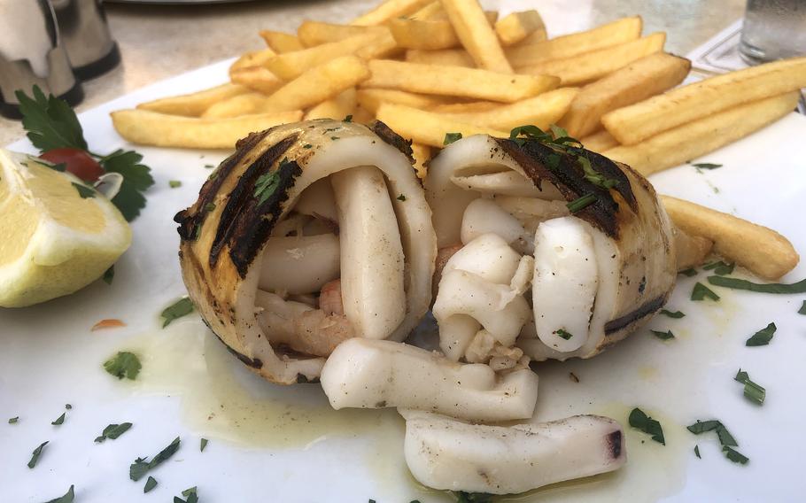 The stuffed grilled calamari at Piazza in Griesheim is a squid tube filled with seafood, served with fries and a side salad. 