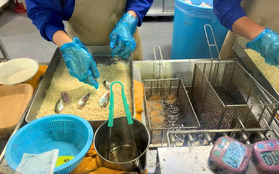 An Umi Farm Kitchen worker prepares freshly caught fish at Yokohama Hakkeijima Sea Paradise near Yokohama, Japan, Oct. 1, 2023.