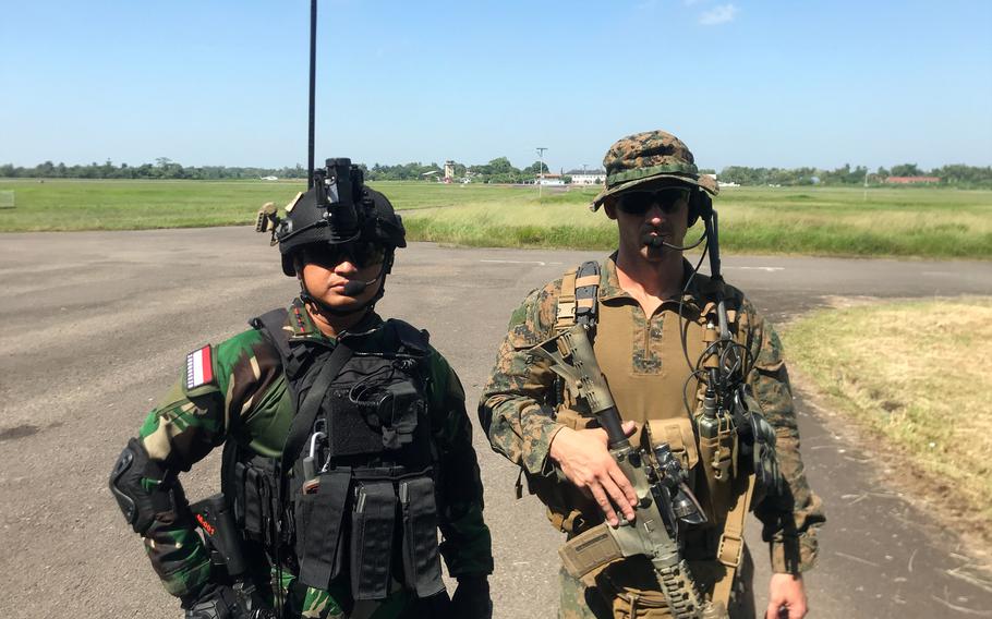 U.S. Marine Capt. Josh Cuyler and Indonesian air force Lt. Col. Tri Wicaxsono pose Tuesday, Aug. 9, 2022, in Palembang, Indonesia, during Super Garuda Shield. The exercise involves 2,000 American and 2,000 Indonesian troops.