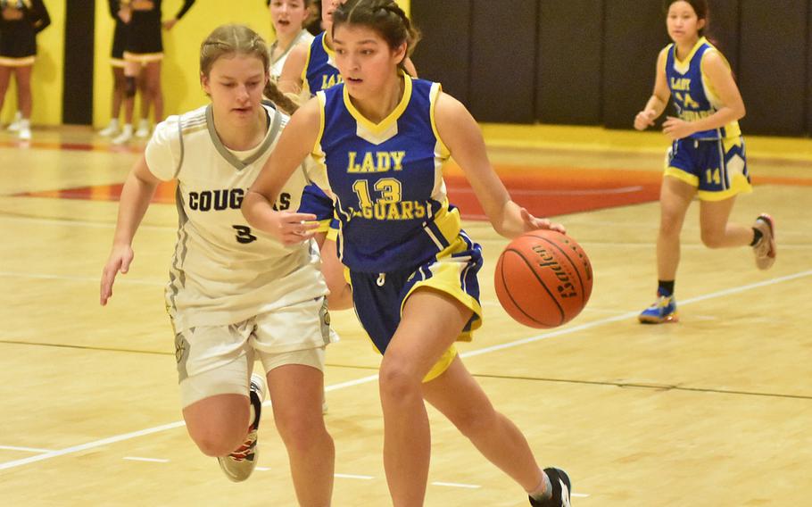 Vicenza’s Mackenzie Blue shadows Sigonella’s Ryleigh Denton down the court Friday, Jan. 6, 2023, in the Cougars’ 36-23 victory over the Jaguars.