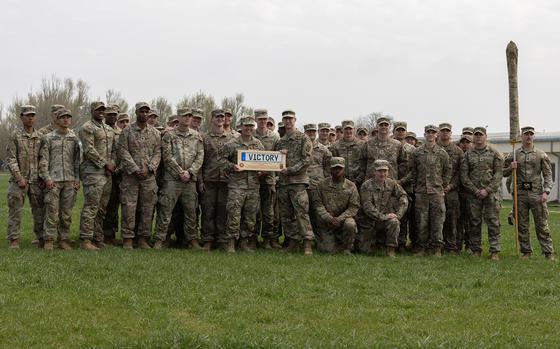Army Command Sgt. Maj. Phillip Blaisdell, V Corps senior enlisted adviser, presents a plaque to the outgoing soldiers from 3rd Brigade, 10th Mountain Division after a transfer of authority ceremony March 26, 2025, at Mihail Kogalniceanu Air Base, Romania.