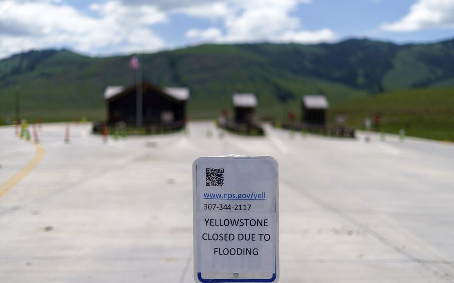 A sign outside the entrance to Yellowstone National Park is seen on June 15, 2022, in Gardiner, Mont.  Created in 1872 as the United States was recovering from the Civil War, Yellowstone was the first of the national parks that have been referred to as America’s best idea. 