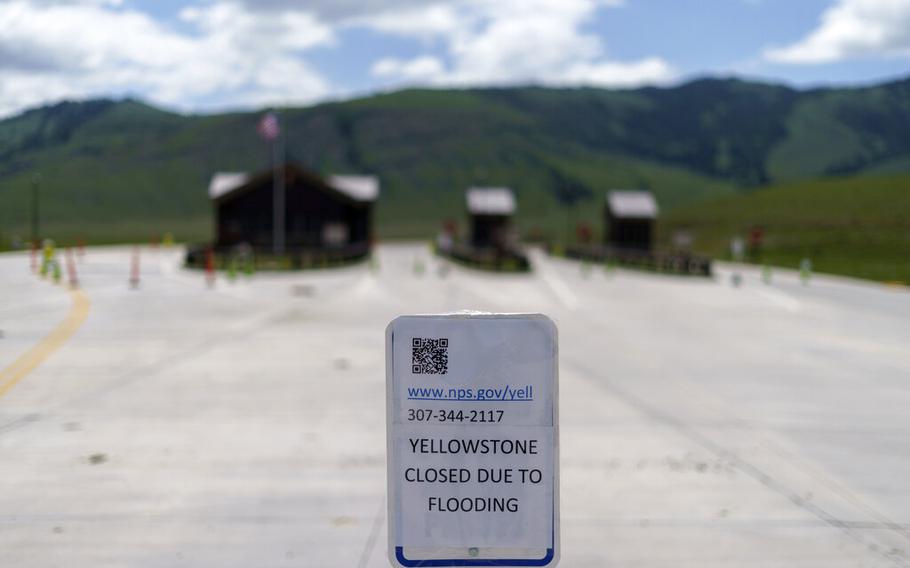 A sign outside the entrance to Yellowstone National Park is seen on June 15, 2022, in Gardiner, Mont. Created in 1872 as the United States was recovering from the Civil War, Yellowstone was the first of the national parks that have been referred to as America’s best idea.