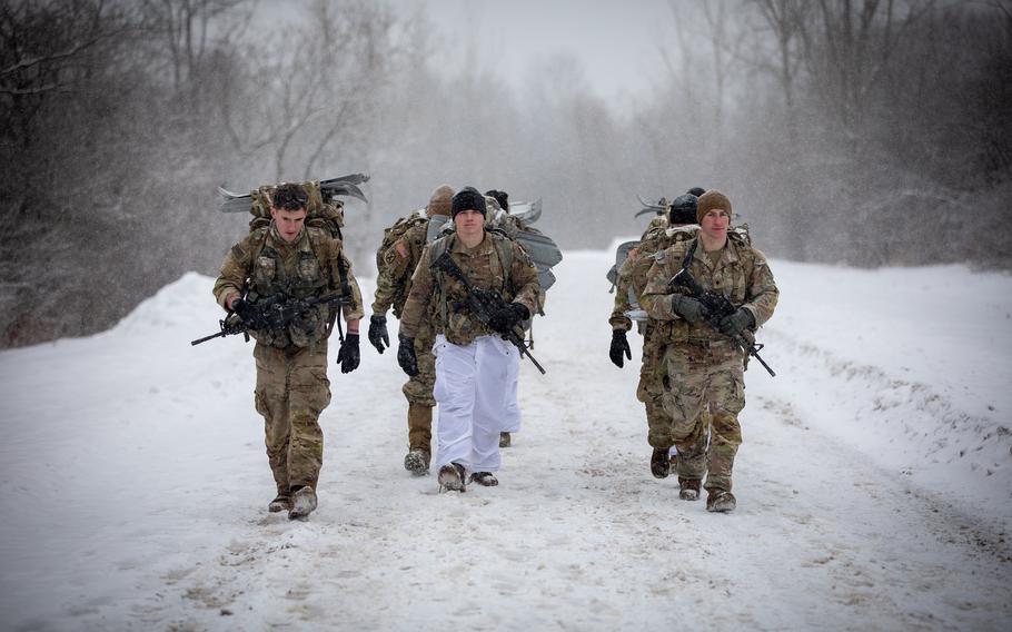 10th Mountain Division soldiers hike a snowy path during a winter competition on February 3, 2022, on Fort Drum, N.Y. 