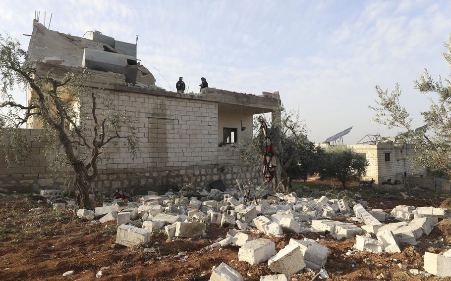 People check a destroyed house after an operation by the U.S. military in the Syrian village of Atmeh, in Idlib province, Syria, Thursday, Feb. 3, 2022. U.S. special forces carried out what the Pentagon said was a successful, large-scale counterterrorism raid in northwestern Syria early Thursday. Local residents and activists said civilians were also among the dead. 