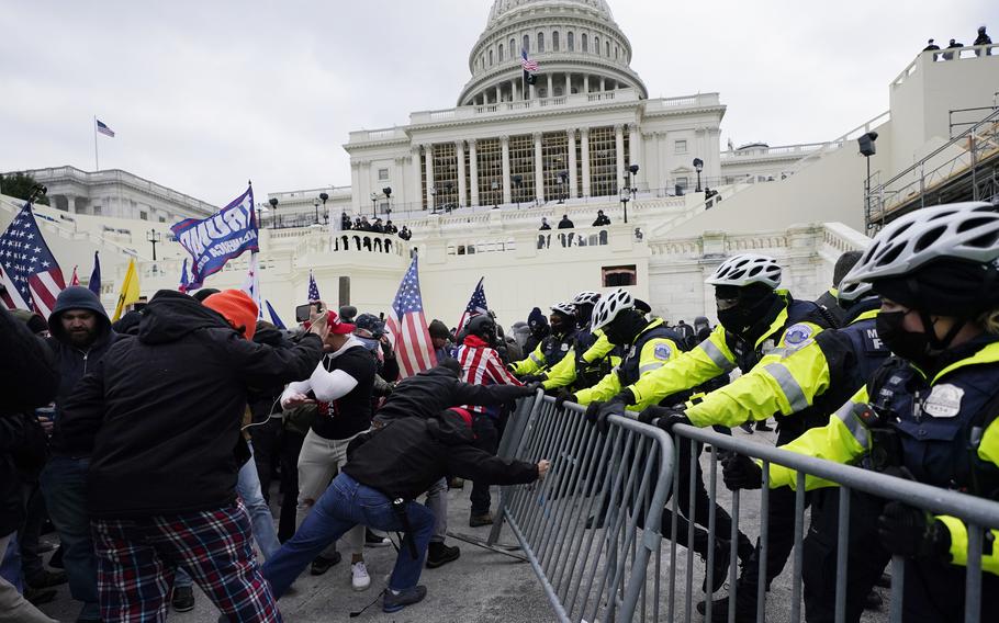Rioters supporting former President Donald Trump try to break through a police barrier at the Capitol in Washington on Jan. 6, 2021.