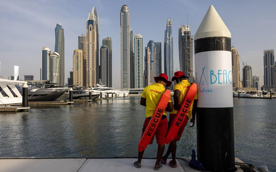 Lifeguards patrol by the water backdropped by residential skyscrapers during the Dubai International Boat Show in Dubai, United Arab Emirates, on March 9, 2022. 