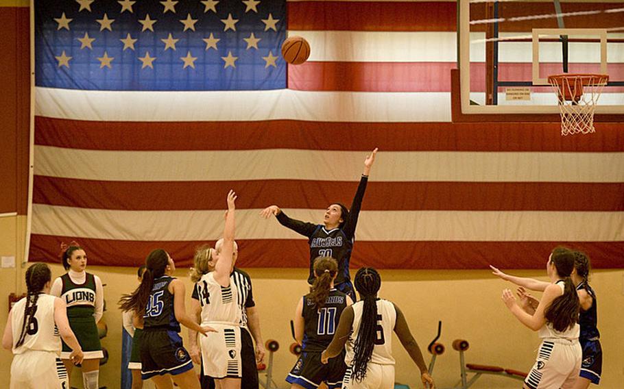 Brussels' Haley Mitchell contests a jump shot by AFNORTH’s Kailey Koger during a DODEA-Europe Division III basketball semifinal game Friday, Feb. 17, 2023, in Baumholder, Germany.