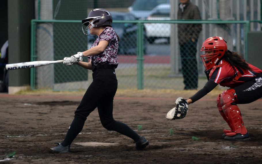 Matthew C. Perry's Sera Shimakura smacks a single in front of E.J. King catcher Moa Best during Friday's DODEA-Japan softball game. The Samurai won 10-6 and later tied Canadian Academy 3-3.