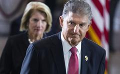 Sen. Joe Manchin, D-W.Va., and Sen. Shelley Moore Capito, R-W.Va., pay their respects as the flag-draped casket bearing the remains of Hershel W. "Woody" Williams, lies in honor in the U.S. Capitol, Thursday, July 14, 2022 in Washington. Manchin has told Senate Majority Leader Chuck Schumer that he will oppose a economic measure if it includes climate or energy provisions or boosts taxes on the rich or corporations. (Tom Williams/Pool photo via AP)