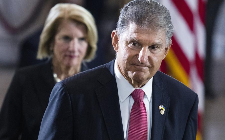 Sen. Joe Manchin, D-W.Va., and Sen. Shelley Moore Capito, R-W.Va., pay their respects as the flag-draped casket bearing the remains of Hershel W. “Woody” Williams, lies in honor in the U.S. Capitol, Thursday, July 14, 2022 in Washington.