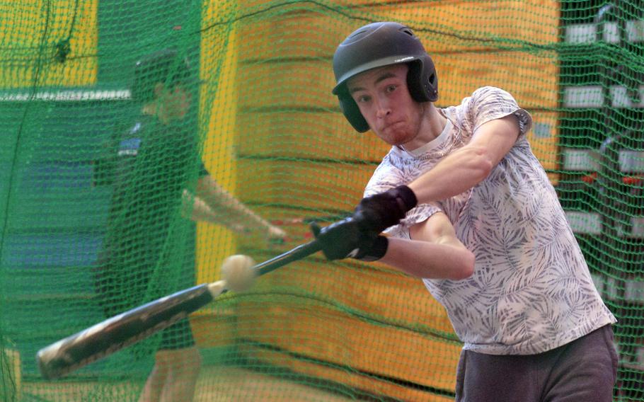 Robert D. Edgren senior Evan Kunns takes his turn in the indoor batting cage in the high school gym.
