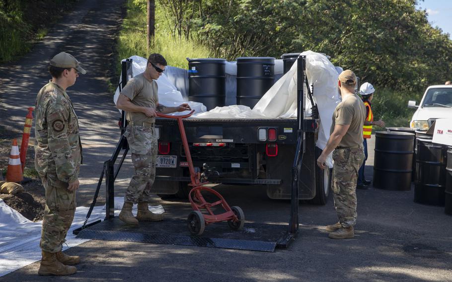 Airmen transport drums containing soil contaminated by toxic fire suppressant chemicals from the Red Hill fuel facility in Honolulu to a holding site at Joint Base Pearl Harbor-Hickam, Hawaii, Dec. 1, 2022.