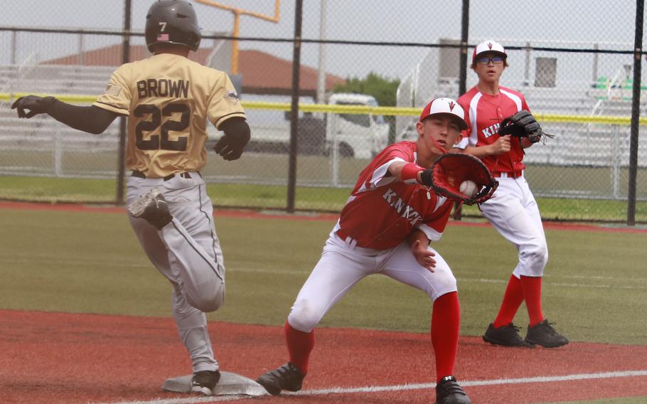 Humphreys' Donovan Brown triies to beat the throw to Kinnick first baseman Aiden Johnson during Tuesday's Division I baseball playoff game. The Red Devils won 7-2.