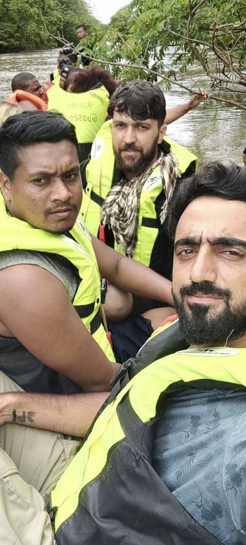 In this photograph provided by Sami-ullah Safi, Abdul Wasi Safi, bottom right, takes a selfie near the Darien Gap, a stretch of land that separates Colombia and Panama, in the summer of 2022, during his journey to the U.S in 2022. 