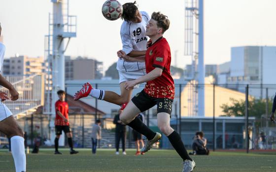 Zama's Connor McCale heads the ball next to Kinnick's Nate Coffey.