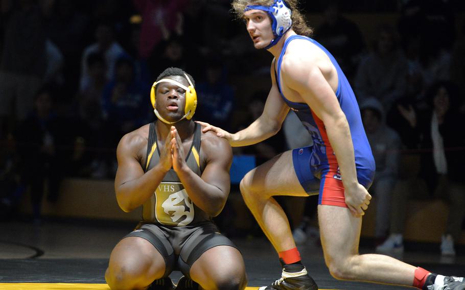 Daniel Bagoudou says a little prayer after defeating Ramstein’s Evan Brooks in the 215-pound final at the DODEA-Europe wrestling championships, in Wiesbaden, Germany, Feb. 11, 2023.