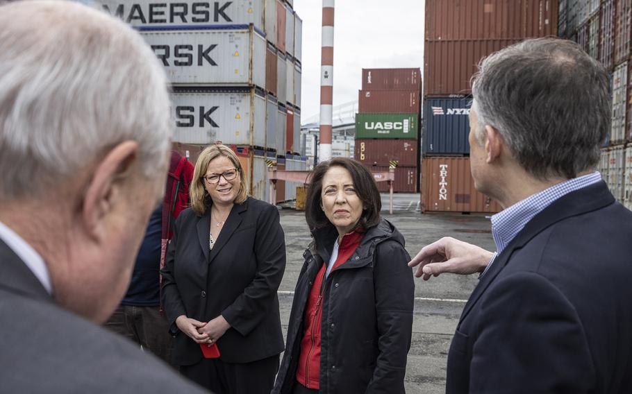 Senator Maria Cantwell and USDA Under Secretary for Marketing and Regulatory Programs Jenny Lester Moffitt at left listen during a tour of Seattle's Northwest Seaport Alliance's Terminal 46 where over 7,000 containers sit ready to be picked up and filled or filled and waiting to be loaded onto ships.