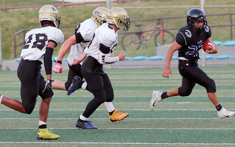 Osan running back Edward Kim gets chased by a pack of Humphreys defenders.