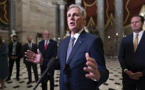 FILE - House Speaker Kevin McCarthy, R-Calif., joined by Rep. August Pfluger, R-Texas, right, and other GOP members, talks to reporters just after voting to advance appropriations bills on the House floor, at the Capitol in Washington, Tuesday night, Sept. 26, 2023. McCarthy is digging in on his refusal to take up Senate legislation designed to keep the federal government fully running beyond midnight Saturday, Sept. 30. (AP Photo/J. Scott Applewhite, File)