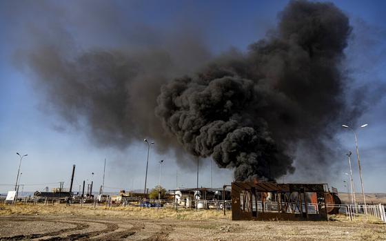 A smoke rises from an oil depot struck by Turkish air force near the town of Qamishli, Syria, Wednesday, Nov. 23, 2022. Turkey's president says he will carry out a land invasion into Kurdish areas of northern Syria. Recep Tayyip Erdogan's statement in Ankara Wednesday came after Turkey carried out a barrage of airstrikes on suspected Kurdish militants in northern Syria and Iraq in recent days. (AP Photo/Baderkhan Ahmad)