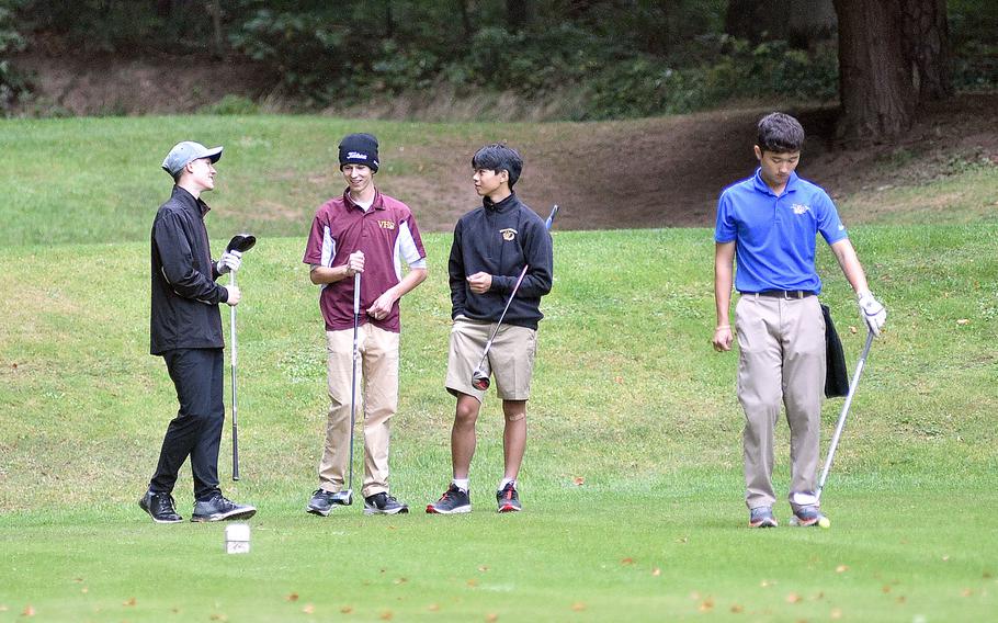 From left, Ramstein's Tyler Hacker, Vilseck's Finneas Horgan and Stuttgart's Edmund Gavina chat while Wiesbaden's Brian Grieve gets ready to tee off on the No. 9 hole at Woodlawn Golf Course during the first day of the DODEA European golf championships on Oct. 12, 2023, on Ramstein Air Base, Germany.