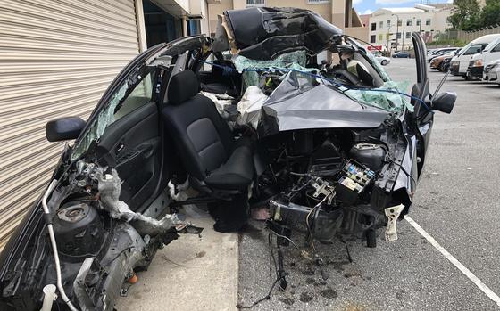 A U.S. soldier assigned to Kadena Air Base was killed Sunday, Sept. 24, 2023, when his black Mazda Axela, seen here the next day at Okinawa Police Station, crossed the median and struck a concrete utility pole.