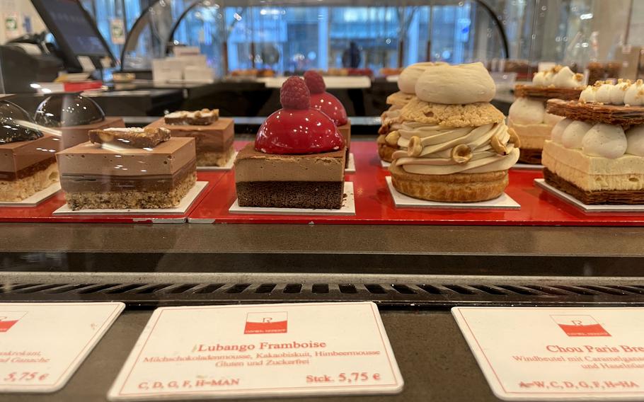 A display of French pastries tempts customers as they walk through the front doors of Engelhorn, an upscale department store in the heart of Mannheim’s shopping district in Germany.