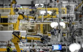 FILE - Articulated robots move inside the Hanwha Qcells Solar plant, Oct. 16, 2023, in Dalton, Ga. On Thursday, April 25, 2024, the U.S. government issues the first of three estimates of economic growth in the first quarter. (AP Photo/Mike Stewart, File)