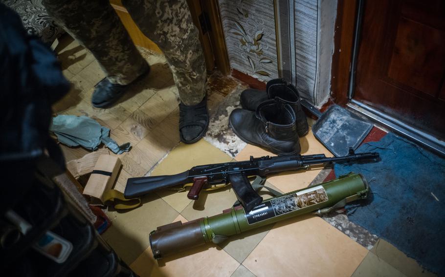 Oleksandr, a retired Ukrainian military officer in Bila Tserkva who declined to give his last name and lives in a building damaged by bombing, displays weapons he says he plans to use against Russian troops. 