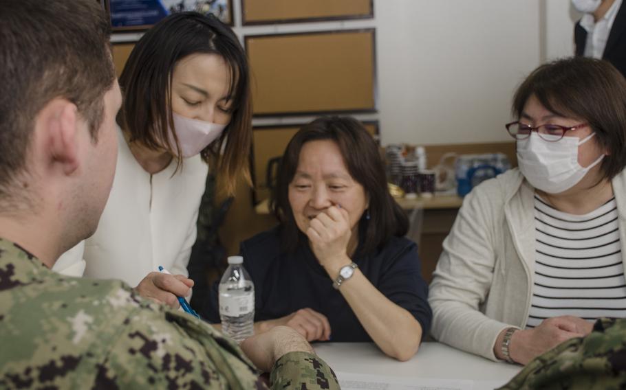 Sailors from the USS Ronald Reagan and Japanese visitors spent several hours getting to know each other during a cultural exchange at Yokosuka Naval Base, Japan, on March 29, 2023. 