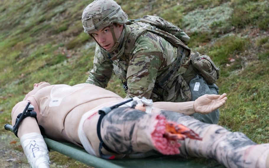 A U.S. Army medic works on a dummy during a medical competition.