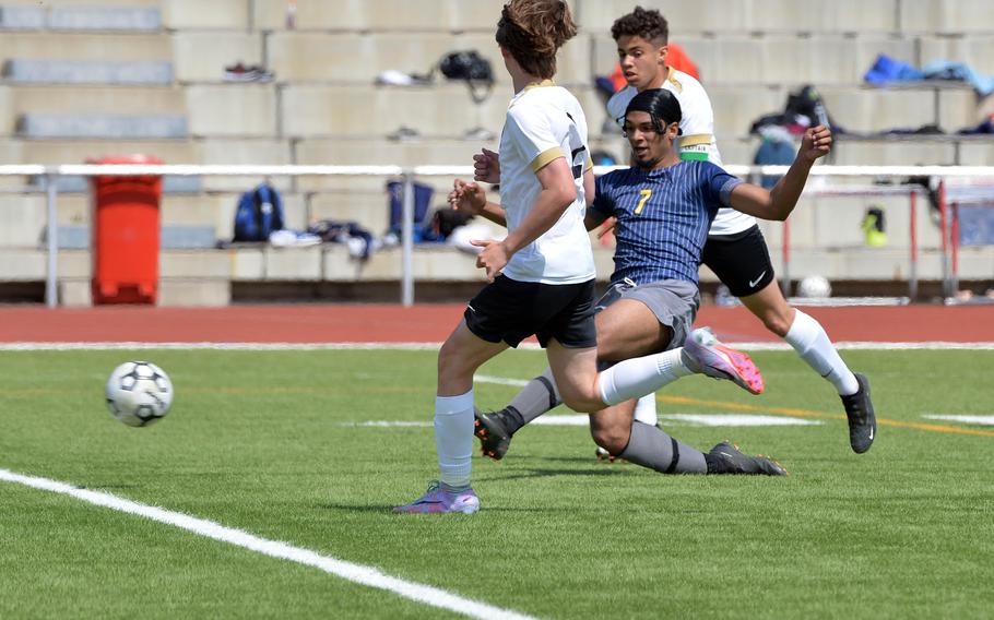 Ansbach’s Nolan Bokor gets between Alconbury’s Chase Rich, left, and Luis Alejandro to score a goal in the Cougar’s 3-1 win in opening day action at the DODEA-Europe high school soccer championships in Kaiserslautern, Germany.
