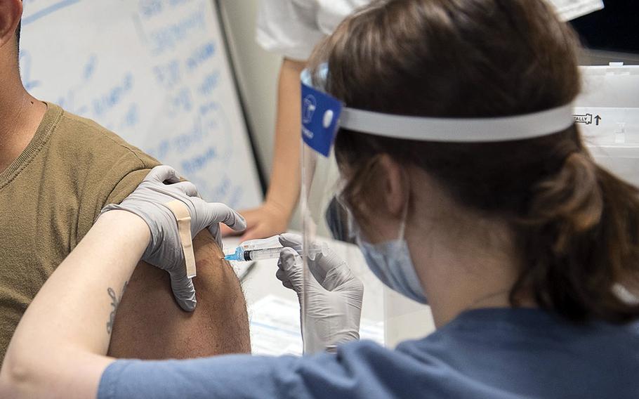 A sailor receives the Moderna COVID-19 vaccine earleir this spring at Naval Air Facility Atsugi, Japan.