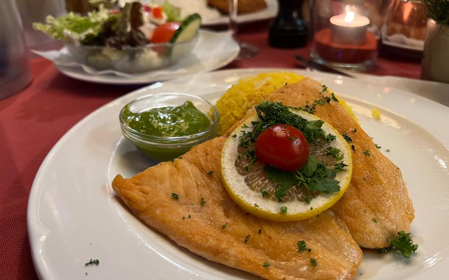 The salmon filet with green sauce and saffron rice at the Duerkheim Giant Barrel in Bad Duerkheim, Germany. The restaurant specializes in traditional German cuisine but offers dishes ranging from pasta to seafood as well.