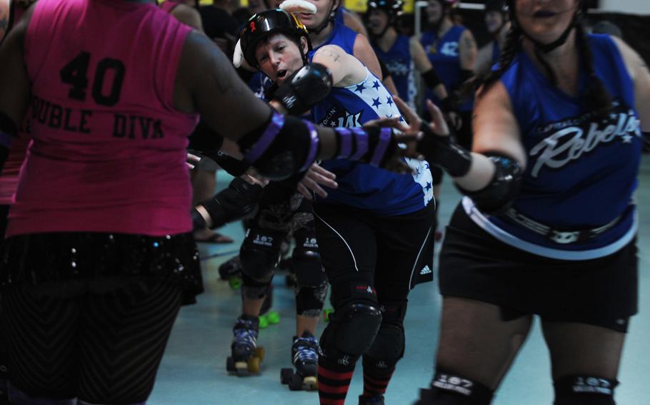 Roller-skaters greet their opponents at a roller derby match.