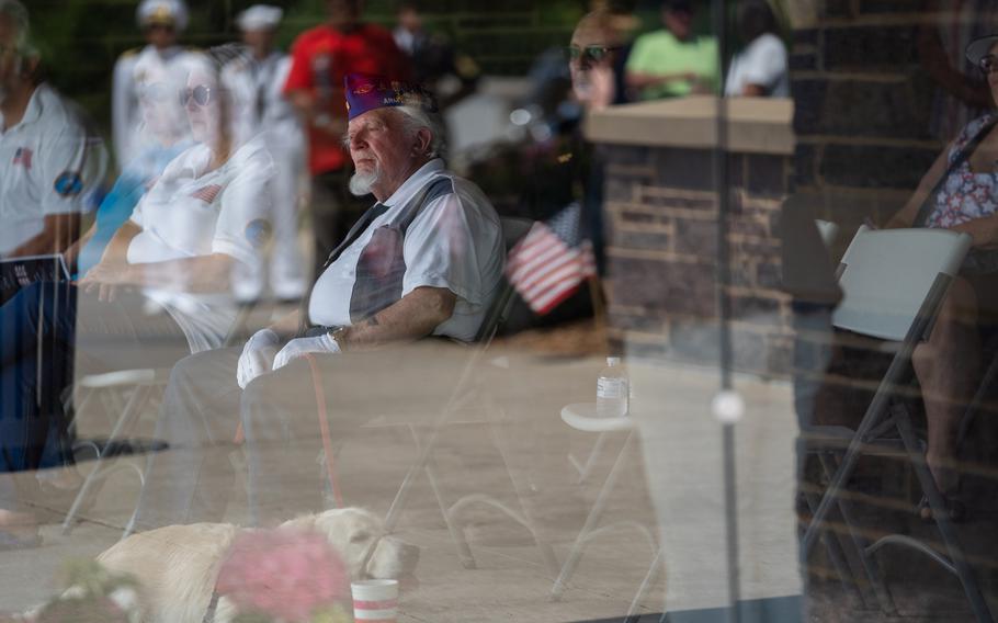 Denny Dorman listens during a memorial service for unclaimed veterans at the Iowa Veterans Cemetery in Adel, Iowa, on June 18.