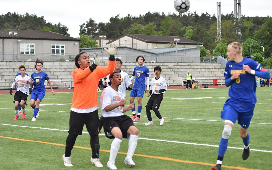 Spangdahlem goalkeeper Jaythan Arriola goes up to punch a corner away over teammate Frederick Cobb in pool play of the Division III DODEA European soccer championship on May 16, 2023, at Kaiserslautern High School in Kaiserslautern, Germany.