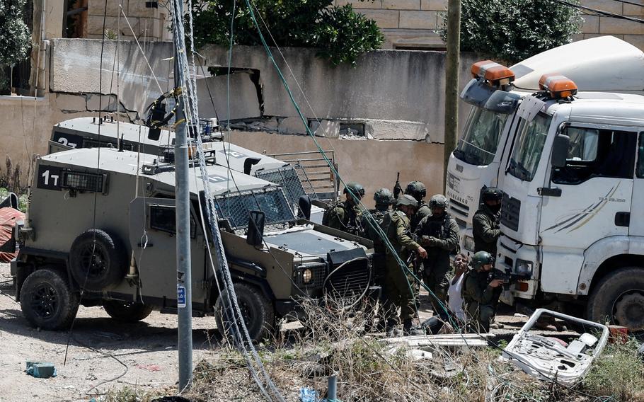 Israeli soldiers detain a Palestinian man during an Israeli raid in Deir al-Ghusun in the Israeli occupied West Bank, May 4, 2024. 
