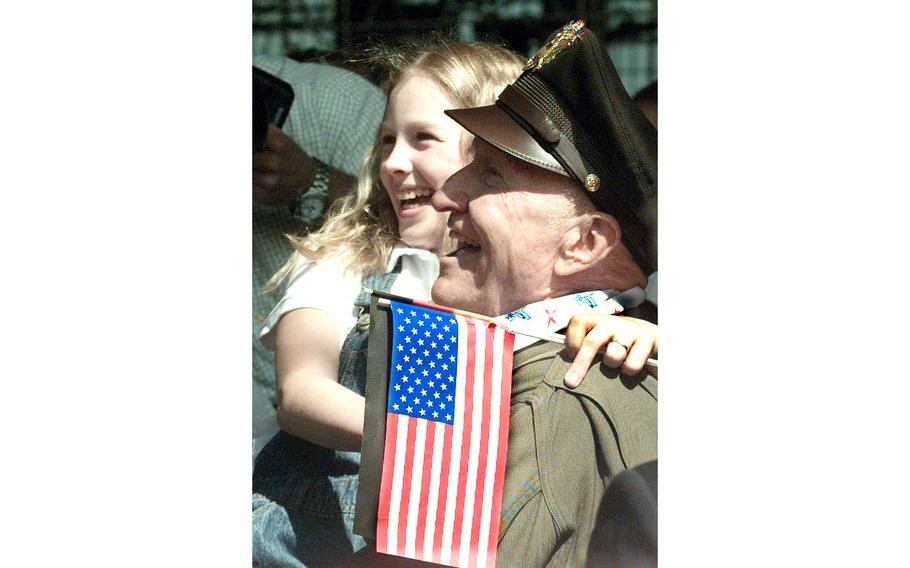 Berlin Airlift veteran Gail Halvorsen poses with a school girl before a ceremony that dedicated an Air Force C-17 Globemaster III “The Spirit of Berlin”. Halvorsen, the original “Candy Bomber” of the airlift, was, along with President Bill Clinton, the star of the ceremony at Berlin’s Templehof airport, May 14, 1998. 