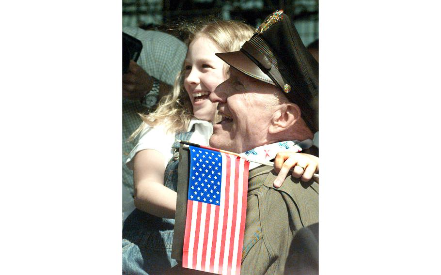 Berlin Airlift veteran Gail Halvorsen poses with a school girl before a ceremony that dedicated an Air Force C-17 Globemaster III “The Spirit of Berlin”. Halvorsen, the original “Candy Bomber” of the airlift, was, along with President Bill Clinton, the star of the ceremony at Berlin’s Templehof airport, May 14, 1998. 