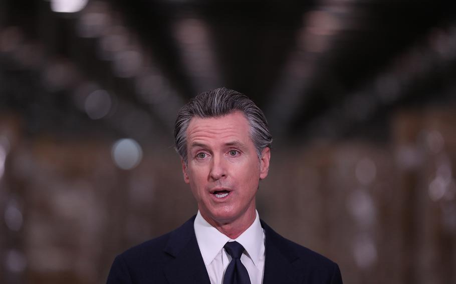 Gov. Gavin Newsom speaks during a press conference to unveil the next phase of California's pandemic response in the UPS Healthcare warehouse filled with personal protective equipment in Fontana, Calif., on Thursday, Feb. 17, 2022. 